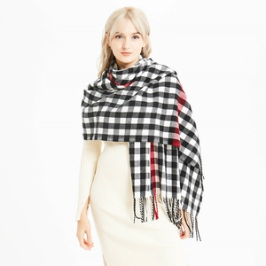 Classic black and white checkered tassel scarf with red accents for winter warmth