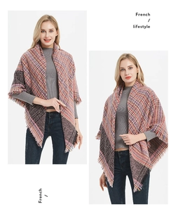 Detail of multi-color plaid shawl with tassel edges in French lifestyle style