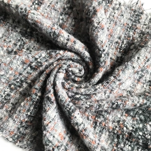 Thick checkered wool scarf with orange accents and textured bouclé yarn weave