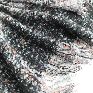 Macro shot of colorful textured knit fabric with soft fringes on a thick winter scarf