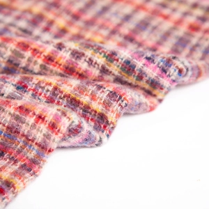 Close-up of multicolor plaid tweed scarf fabric with thick and soft woven texture