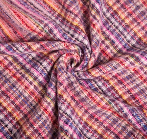 Macro detail of multicolored thick knit tweed fabric showing intricate fiber textures