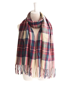 Detail of navy and burgundy plaid scarf with soft fringe texture on a white mannequin