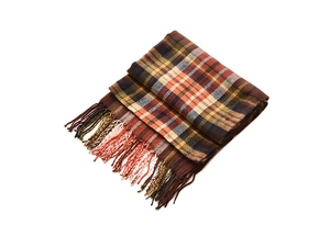 Detail shot of vintage plaid knit scarf with retro colors and handmade fringe trim
