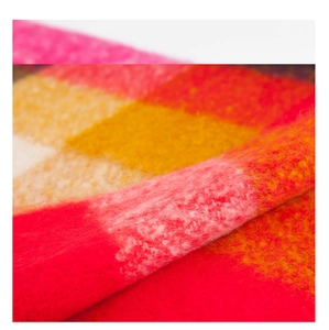 Macro shot of colorful textured plaid scarf with soft plush fringed mohair material