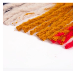 Detailed texture of thick plaid loop yarn scarf in off-white, yellow and red colors