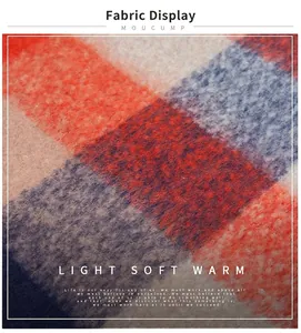 Close-up of soft brushed knit fabric in orange and blue plaid with mohair texture