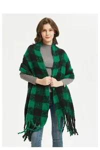 Detail of dark green and black buffalo check scarf with decorative long fringe tassels