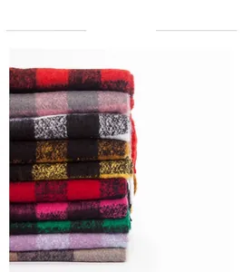 Close-up of thick checkered knit scarves in multiple vibrant colors and soft texture