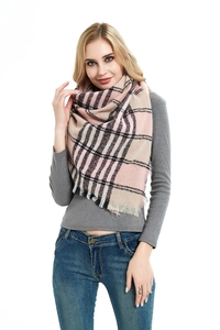 Detail of soft pink and beige plaid scarf with fringed edges in triangular wrap style
