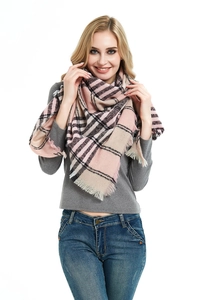 Detail of pink and black plaid scarf featuring thick textured fabric and fringe edges