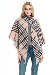 Detail of pink and beige plaid shawl with soft knitted texture and delicate fringe edge