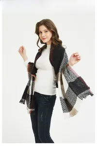 Macro detail of large plaid scarf with fringe and classic houndstooth weave pattern