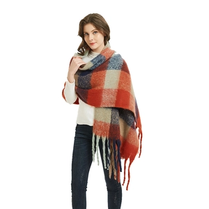 Thick plaid winter scarf for women featuring orange and navy patterns with soft fringe