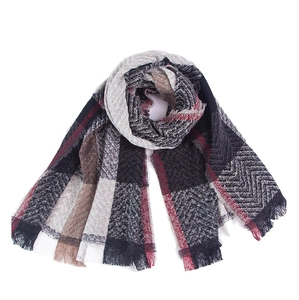 Detail of plaid scarf featuring mixed houndstooth patterns and delicate fringe edges