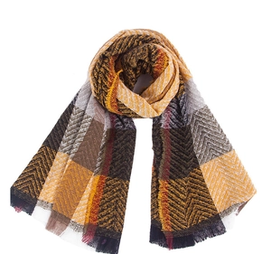 Detailed close-up of plaid winter scarf with tassel fringe and herringbone pattern