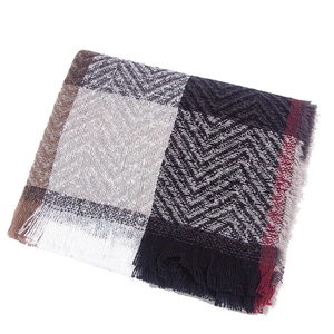 Close-up of a soft checkered scarf with classic herringbone pattern and fine tassels