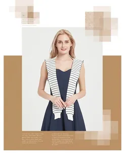 Close-up of black and white striped knitted shawl on navy dress for elegant layering
