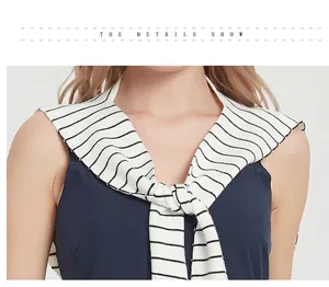 Detail showing a black and white striped knitted shawl collar tied over a navy top