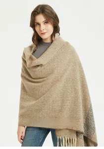 Detailed view of camel cashmere-feel scarf with blue orange plaid and fringe