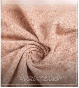 Macro shot of soft camel knit scarf fabric showing its light, warm, and fluffy texture