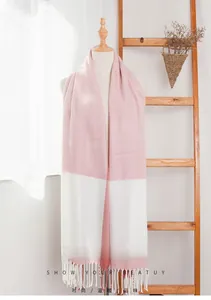 Detail of pink and white color-block cashmere-feel scarf with long decorative tassels