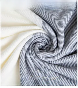 Macro shot of soft knit pashmina fabric with cream and grey stripes, light and warm texture