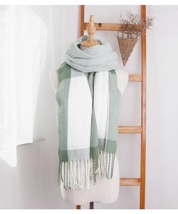 Detail of light green and white oversized check scarf with handmade fringe tassels