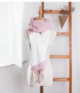 Detailed view of pink and white patchwork scarf with fringes on a female mannequin