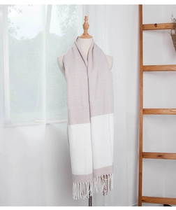 Detailed view of bicolor pashmina shawl with textured twill weave and white fringe trim