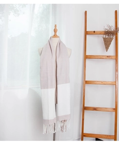 Detail of color-block scarf featuring herringbone weave texture and soft fringe edges