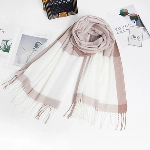 Detail of color-block plaid scarf with soft tassels and warm cashmere-like texture