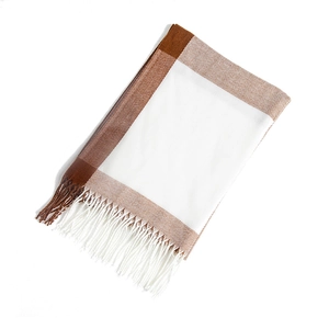 Detail view of brown and beige color-block scarf with soft fringe tassels and woven texture