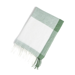 Close-up of green and white checkered cashmere scarf with decorative long tassels