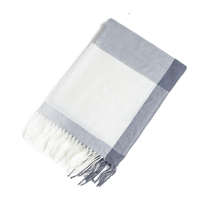 Detail of checkered cashmere pashmina with white and blue color block and fringe tassels
