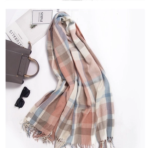 Dettaglio di sciarpa a quadri colorati con nappe morbide e trama effetto cashmere