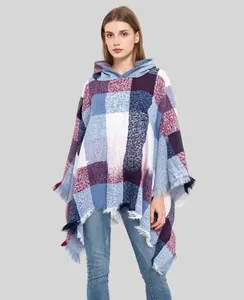 Detail of hooded plaid poncho with thick tassels and vintage checkered pattern
