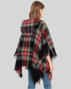 Detail of green plaid hooded poncho with black fringe tassels on a model back view