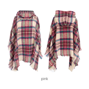 Detailed view of pink plaid hooded poncho with decorative tassel hem for women