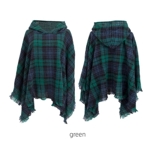 Detail of green plaid hooded poncho featuring soft fringe trim and cozy knitted texture