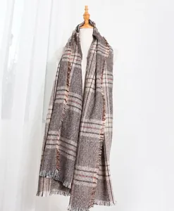 Detailed view of winter houndstooth scarf with classic fringe edges and thick knit texture