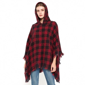 Women's mid-length red and black plaid hooded poncho cape with tassel fringe detail