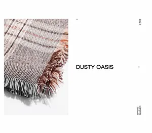 Detail of checkered pashmina shawl with fringe edges in brown beige and orange colors