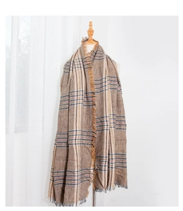 Detailed view of the thick houndstooth pattern and soft tassel edges of the winter scarf