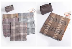 Detail of checkered cashmere-feel scarves with fringed edges in various winter colors