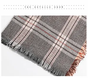 Close-up of woven houndstooth pattern fabric with delicate fringe edge details