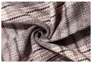 Macro view of soft houndstooth cashmere texture with thick brown and orange plaid pattern
