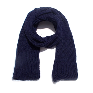 Macro detail of dark blue chunky knit scarf showcasing thick acrylic texture and weave
