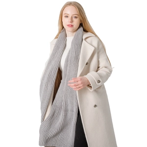 Women's minimalist grey ribbed knit acrylic scarf styled with a white wool coat