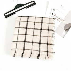 Classic black and white checkered scarf with fringe tassels for autumn and winter outfits